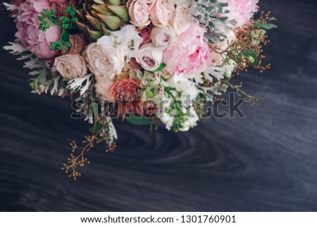 Big beautiful wedding bouquet of spring  flowers on wooden background. Peonies, roses, tulips, grass. Wedding concept.
