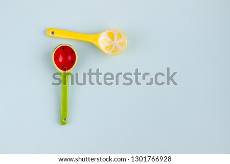 Bright decorative ceramic spoons on colorful background.