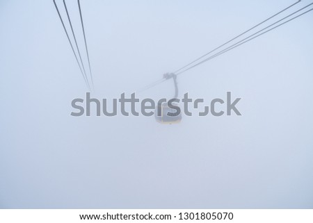 The cable car to mountain top with mist