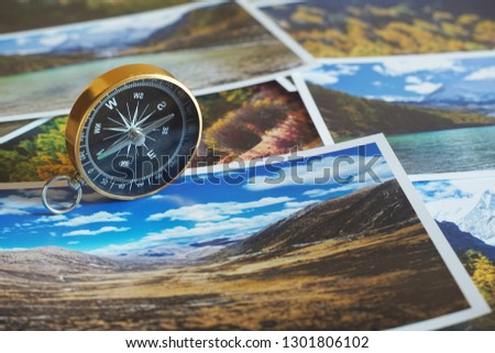 Compass on blur photograph of popular tourist destination background, traveling destination plan concept, copy space