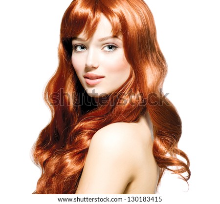 Beauty Girl Portrait. Healthy Long Curly Red Hair. Beautiful Young Woman isolated on a white background