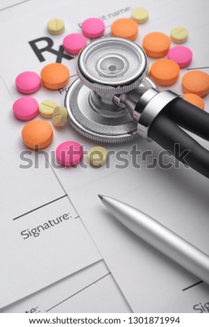 Prescription or Rx form with medical stethoscope, pills and pen on the doctors desk