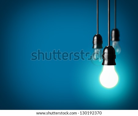 Light bulbs on blue background Royalty-Free Stock Photo #130192370