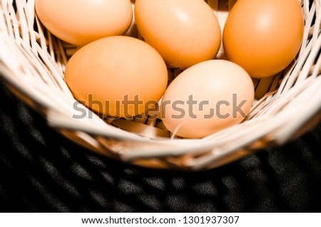 Lots of fresh chicken eggs in the basket from the top view. Organic food ingridients close up. Stay healthy concept.