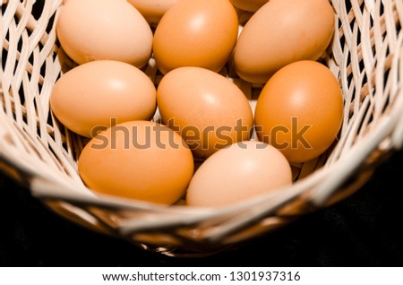 Lots of fresh chicken eggs in the basket from the top view. Organic food ingridients close up. Stay healthy concept.