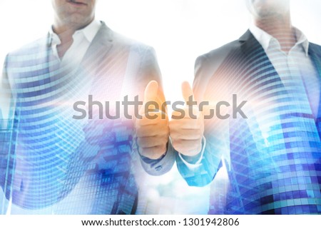 Two business people showing thumb up gesture.Double exposure city background.businessman team.Successful people teamwork.The organization of conferences, event ,seminars, brainstorming.Mixed media.