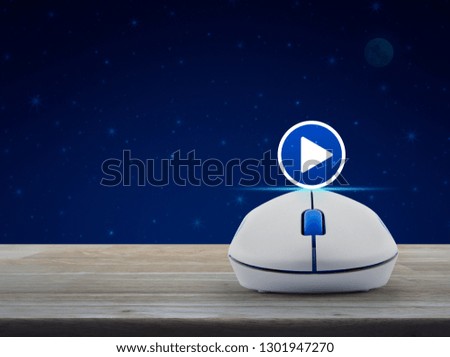 Play button with wireless computer mouse on wooden table over fantasy night sky and moon, Business music online concept