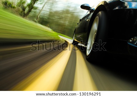 Front side view of black car in turn. Royalty-Free Stock Photo #130196291