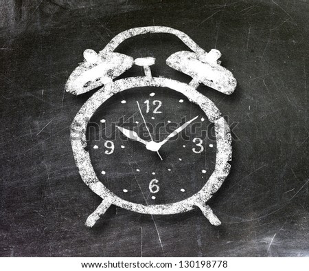 alarm clock on blackboard