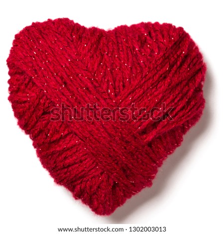 Knitted red heart shape isolated on white background