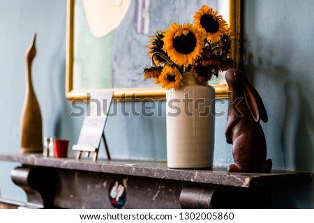 Sunflowers in vase on shelf