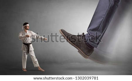 Big foot treading small young karate man