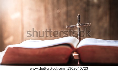 wooden cross in middle of the bible. christian concept.