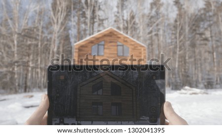 Man is making architecture photography with tablet in winter, home and building concept. Stock. Hands men take photos at home