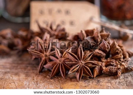 Close up image of star anise spice on wooden board with paper tag.