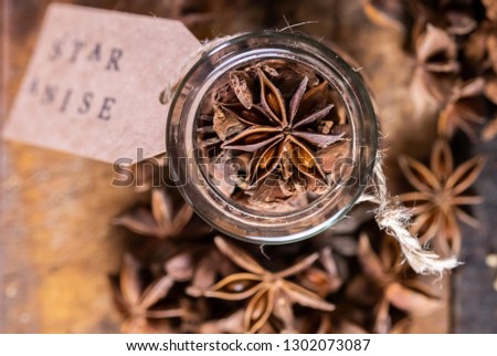 Close up image of star anise spice on wooden board with paper tag.