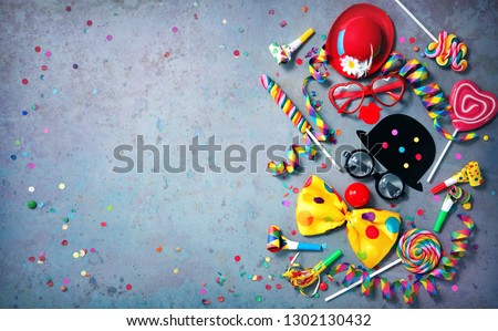 Colorful carnival or party background streamers and confetti and funny faces formed from bow tie, hat, eyeglasses and lips