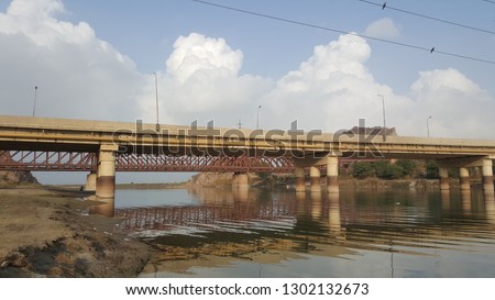 open and public bridge view in images bellow and river environment with water fallowing in the outer side of bridge and river.
here is same most imported object in photo that can define the purpose. 