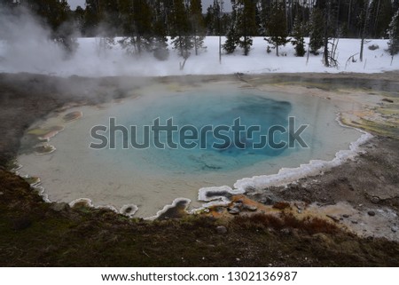A hot spring steams during winter in Yellowstone National Park