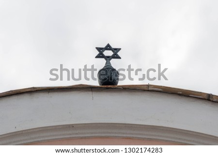 Metal Star of David on local synagogue roof top in Romania.