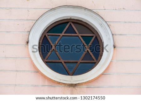Window in the shape of Star of David on a Synagogue in Romania .