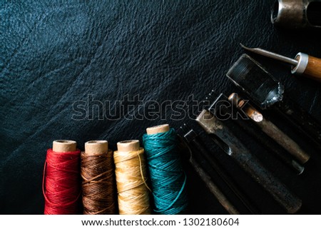 Leather craftsmanship working with tool and colorful of thread, Handmade object