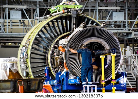Jet engine remove from aircraft (airplane) for maintenance at aircraft hangar.Jet engine maintenance and change part by aircraft technician . Royalty-Free Stock Photo #1302183376