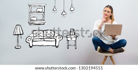 New apartment dream with young woman using her laptop on a grey background