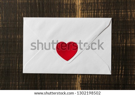 Wooden background. Congratulatory white envelope / card with a heart. Valentine's Day. March 8. Mothers Day. holidays. birthday. Santa. new Year. Christmas.