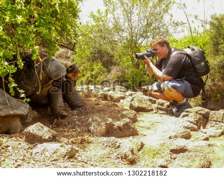 A female photographer and a Galapagos Tortoise