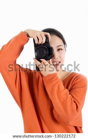 Female photographer in studio using a camera.