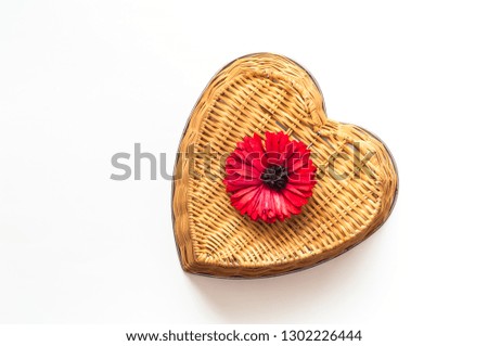 Valentines day greeting postcard. Gerbera flower on wicker texture on white isolated background. Festive concept. Flat lay, top view. Closeup, copy space.