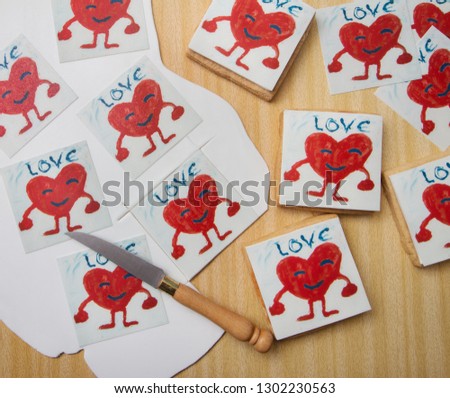 Square fondant cookies for Valentine's Day with children's drawing, red heart. Illustration. Child's drawing Romantic. February 14th. Snack. Love. Crafts.