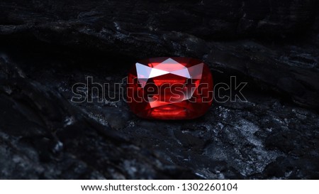 
Red garnet rhodolite on coal background. Royalty-Free Stock Photo #1302260104