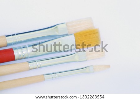 Brushes for painting with oil paints made of synthetic materials on a white background.