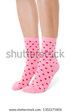 Legs with cute pink socks on white background. Minimalism fashionable  set