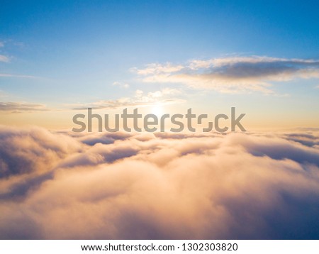 Aerial view White clouds in blue sky. Top view. Drone. Aerial bird's eye fly. Aerial top view cloudscape. Texture of clouds. View from above. Sunrise or sunset over clouds. Panoramic  Royalty-Free Stock Photo #1302303820