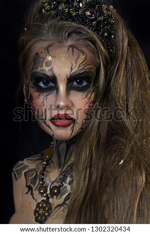 close up portrait of beautiful girl. black face painting . professional creative makeup.