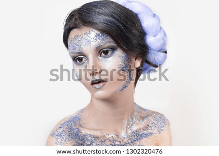 close up portrait of beautiful girl. professional white winter makeup. snow queen with beads on face