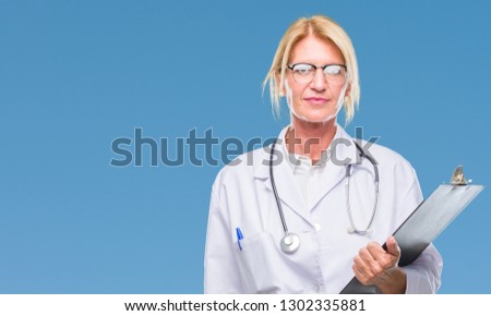 Middle age blonde doctor woman holding clipboard over isolated background with a confident expression on smart face thinking serious