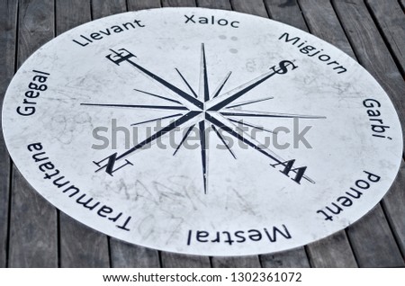 Metal engraved compass located on the oil bridge, Pont de Petroli beach in Badalona, near Barcelona.
