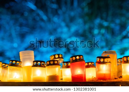 Burning Candles in Yellow and Red Colors with Shallow Depth of Field With Blue Background and Space For Text - 02.02.2019 event "Raunas Staburags, dzejas dienas", Concept of faith and religion