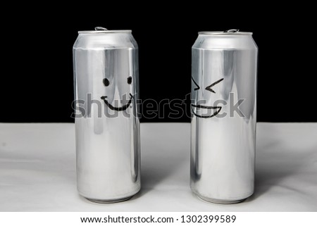 Concept of talking friends. Smile and laugh emoji. dialog of two aluminium cans on black background. Emotions