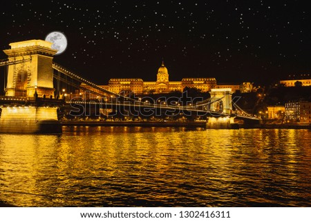  Night Budapes.Capital of Hungary.Beautiful big old town.The photo is made in the dark.The magnificent city is rich in history.City landscape with a wide large river.Beautiful golden city.