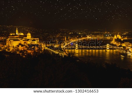 Panorama night Budapes.Capital of Hungary.Beautiful big old town.The photo is made in the dark.The magnificent city is rich in history.City landscape with a wide large river.Beautiful golden city.