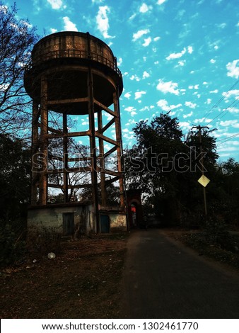 there is a water tank and a blue sky. these both make attractive this picture. 