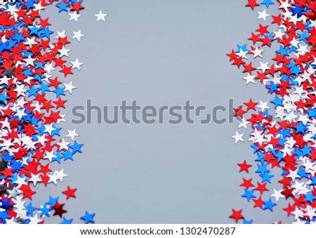 Red white blue shiny confetti stars on grey  background, tricolor concept, independence and freedom day USA.