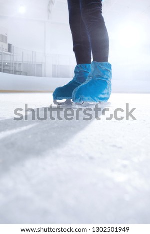 close up view of figure skater on dark ice arena background