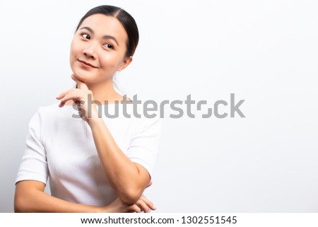 Happy woman is pointing to copy space isolated over white background
