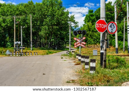 Stop sign in front of railroad crossing